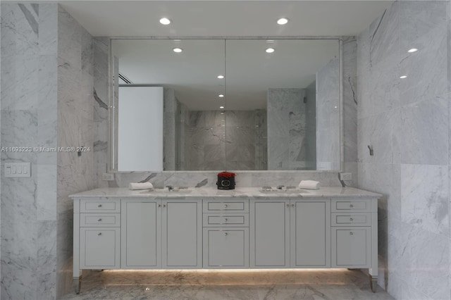 bathroom featuring vanity and tile walls