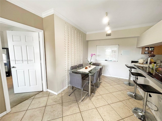 kitchen with light tile patterned flooring and ornamental molding