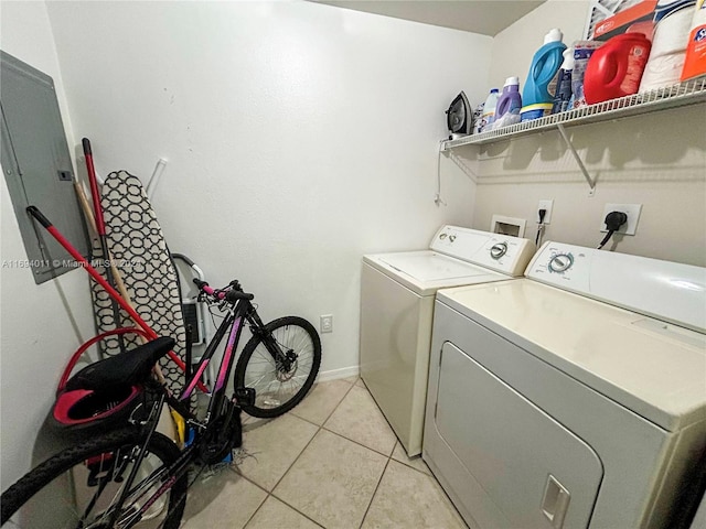 clothes washing area featuring independent washer and dryer and light tile patterned flooring