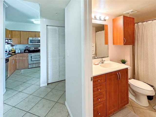 bathroom with tile patterned floors, vanity, ornamental molding, and toilet