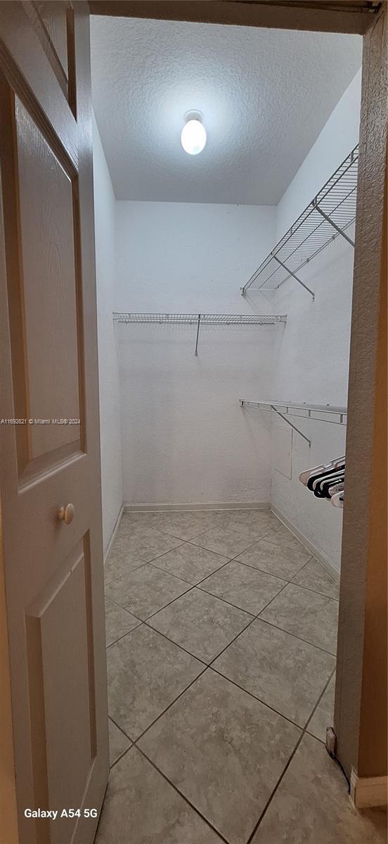 spacious closet featuring light tile patterned floors