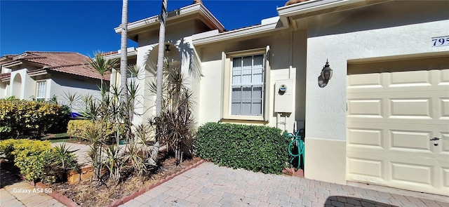 doorway to property with a garage