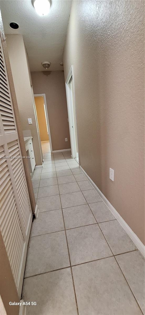 hallway featuring light tile patterned floors