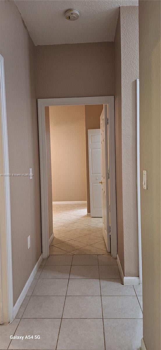 hallway featuring light tile patterned floors