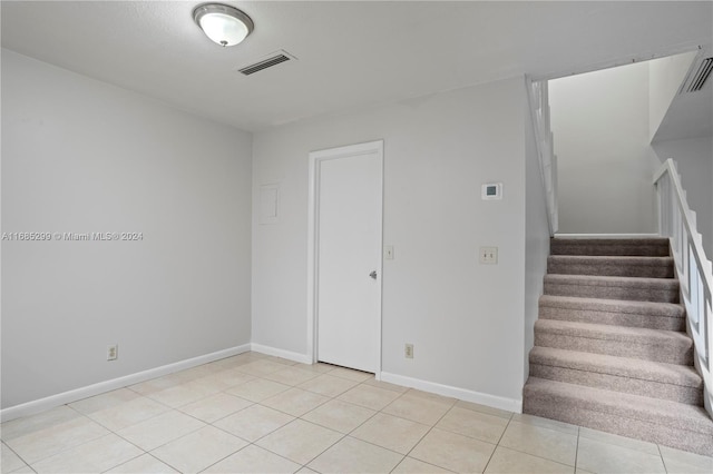 staircase with tile patterned floors