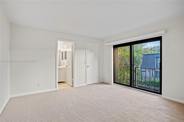 unfurnished room featuring light colored carpet