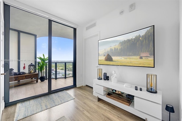 121 NE 34th St Unit 3014, Miami, FL 33137 - sitting room featuring a wall of windows and wood finished floors