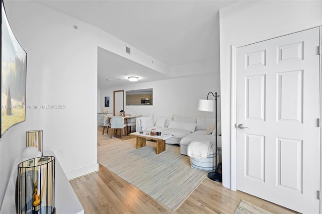 121 NE 34th St Unit 3014, Miami, FL 33137 - living room with light wood-style floors and baseboards