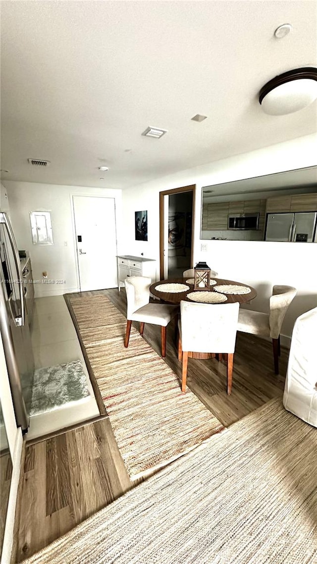 interior space featuring hardwood / wood-style flooring and a textured ceiling