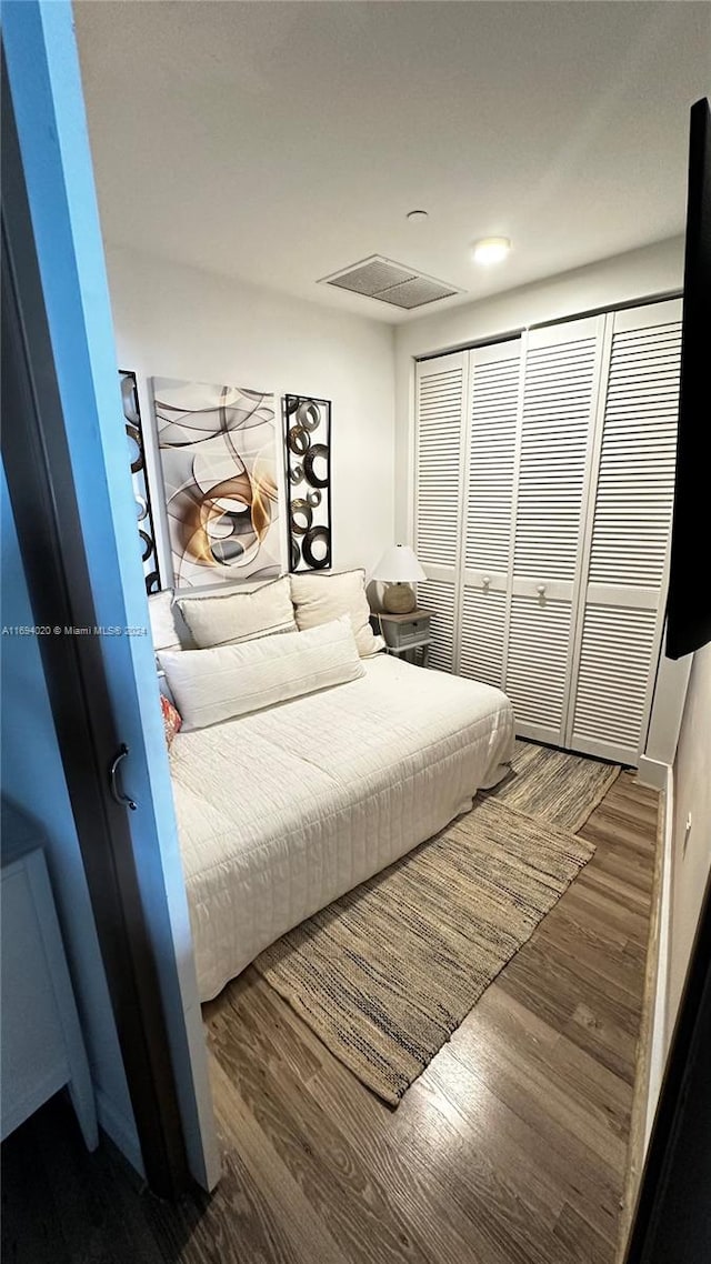 bedroom featuring a closet and hardwood / wood-style flooring