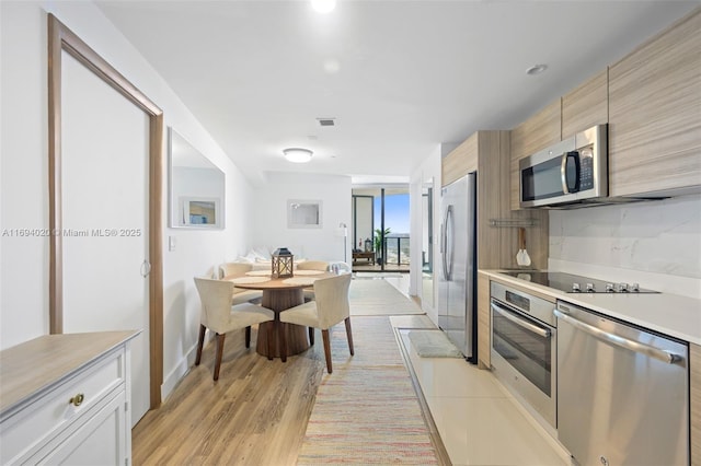 121 NE 34th St Unit 3014, Miami, FL 33137 - kitchen featuring appliances with stainless steel finishes, light countertops, and light wood-style floors