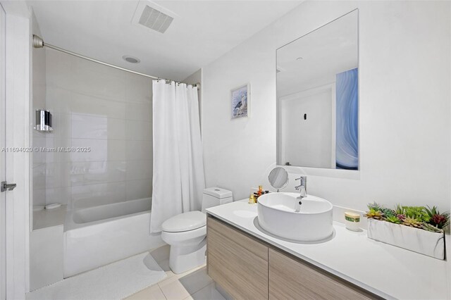 121 NE 34th St Unit 3014, Miami, FL 33137 - bathroom featuring vanity, shower / bath combo with shower curtain, toilet, and tile patterned floors