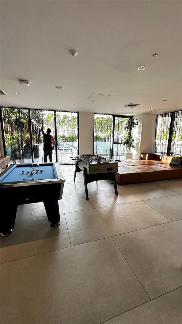 rec room with a wall of windows and pool table