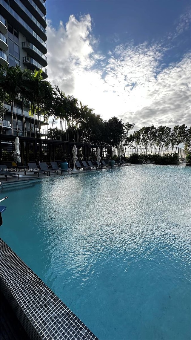 view of swimming pool featuring a water view