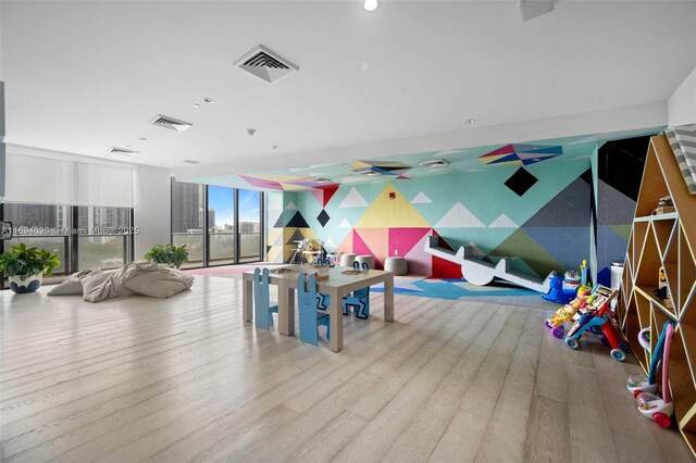 121 NE 34th St Unit 3014, Miami, FL 33137 - rec room featuring wood finished floors, recessed lighting, and floor to ceiling windows