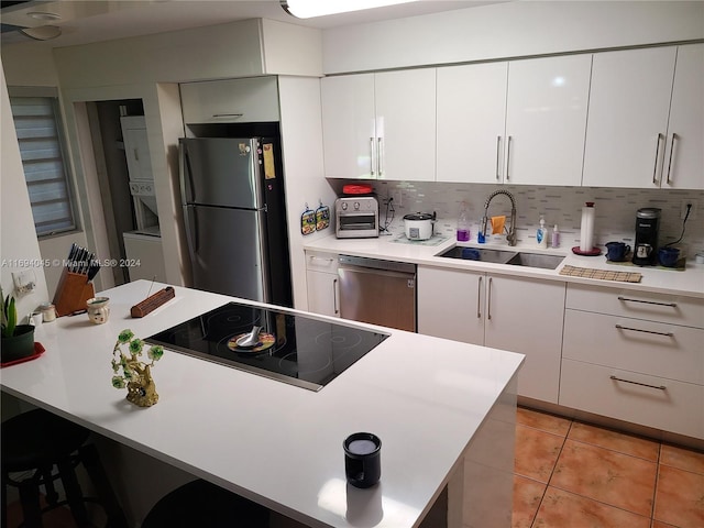 kitchen featuring white cabinetry, sink, and appliances with stainless steel finishes