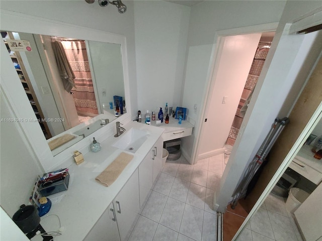 bathroom featuring tile patterned flooring, vanity, toilet, and curtained shower