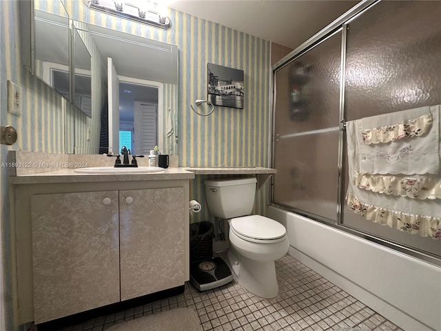 full bathroom featuring tile patterned flooring, vanity, enclosed tub / shower combo, and toilet