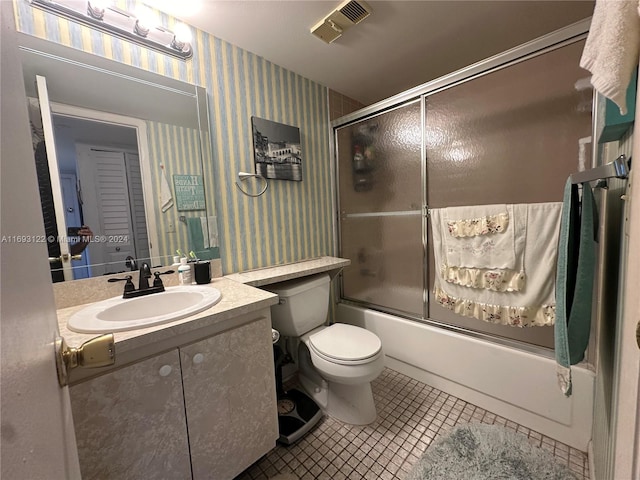 full bathroom featuring tile patterned floors, vanity, combined bath / shower with glass door, and toilet