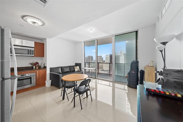 tiled dining area with a wall of windows