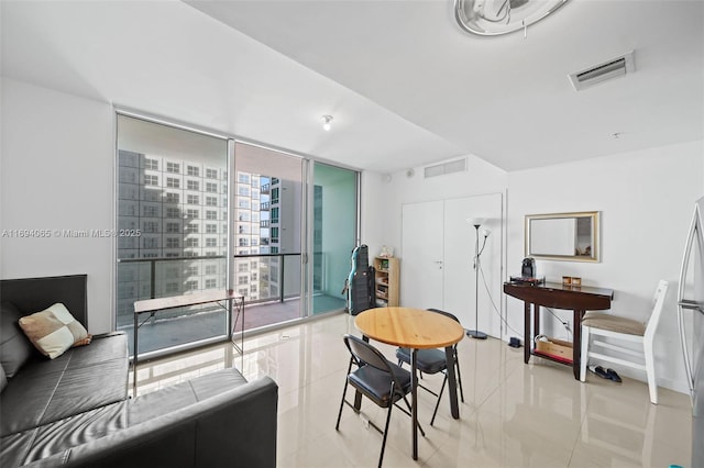 tiled dining space featuring floor to ceiling windows