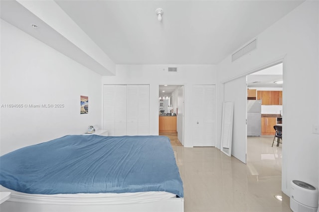 bedroom with white refrigerator and a closet