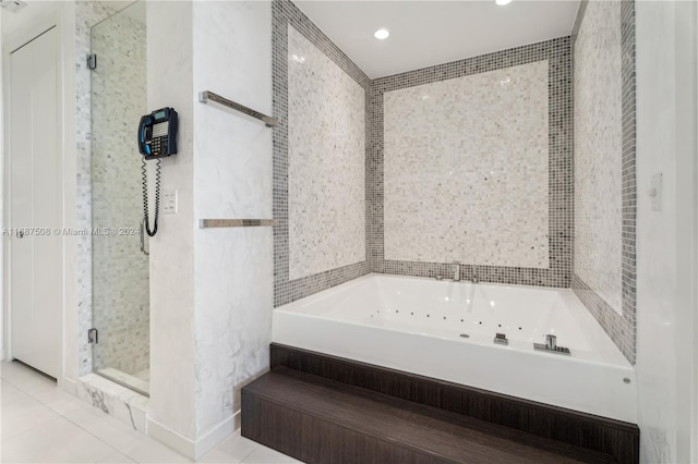 bathroom with tile patterned floors and independent shower and bath