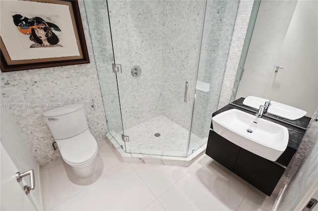 bathroom with tile patterned floors, vanity, walk in shower, and toilet