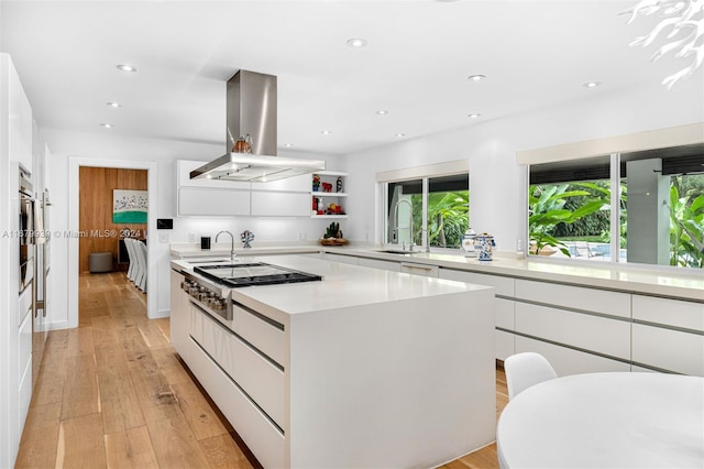 kitchen featuring a kitchen island, white cabinets, and island exhaust hood