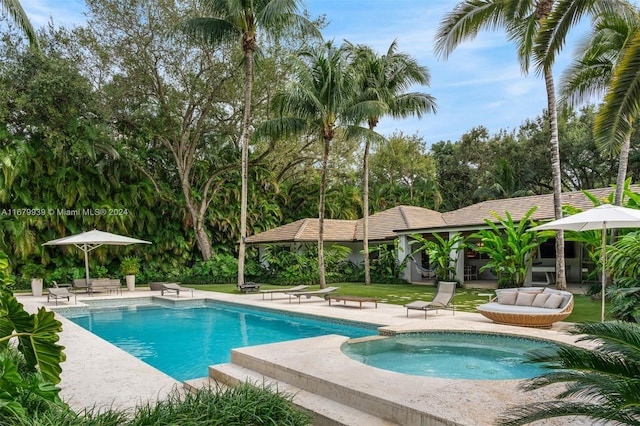 view of pool with an in ground hot tub and a patio area