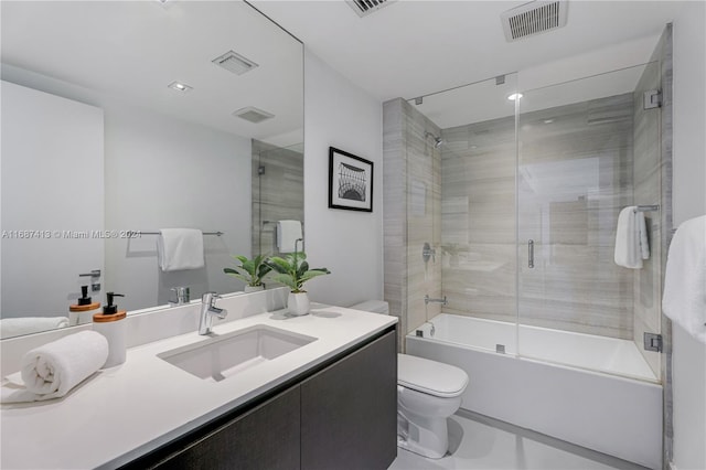 full bathroom with vanity, enclosed tub / shower combo, and toilet