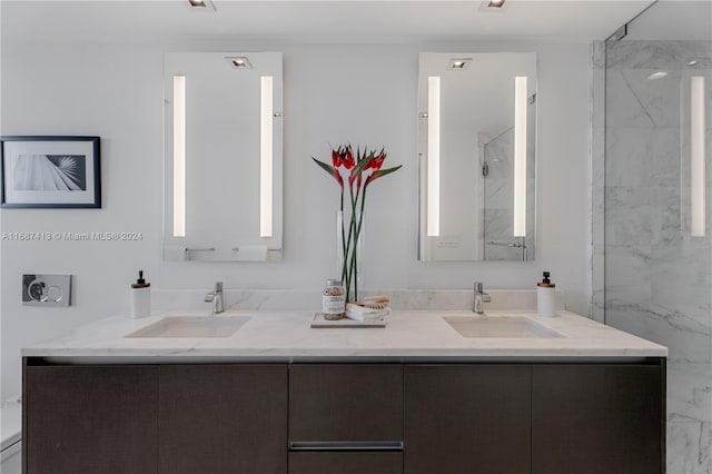 bathroom with vanity and tiled shower