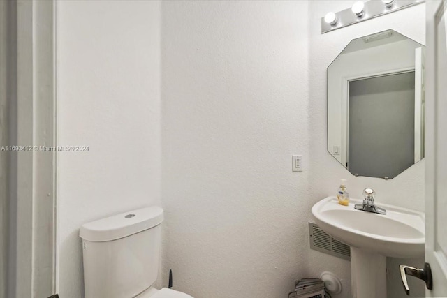 bathroom with toilet and sink