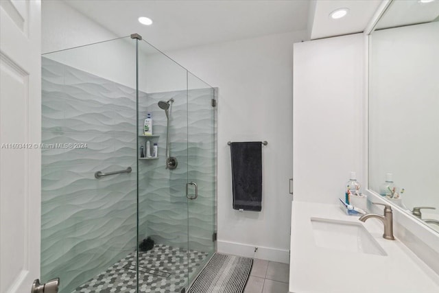 bathroom featuring vanity, tile patterned floors, and an enclosed shower