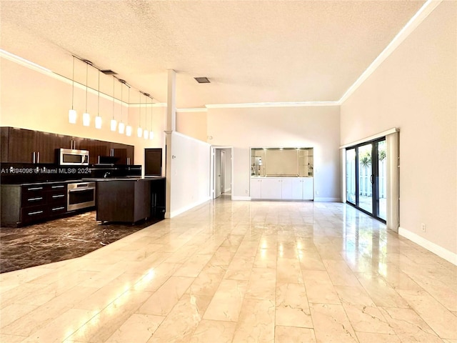 kitchen featuring hanging light fixtures, a high ceiling, a textured ceiling, and appliances with stainless steel finishes