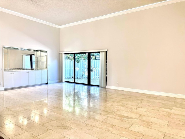 spare room with crown molding, a towering ceiling, and a textured ceiling