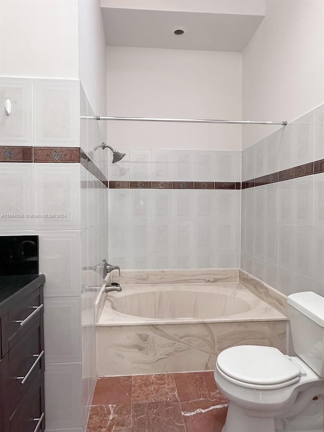 full bathroom featuring vanity, toilet, and tiled shower / bath