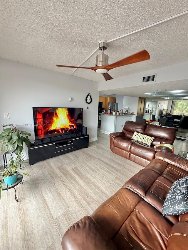 living room with hardwood / wood-style floors and a textured ceiling