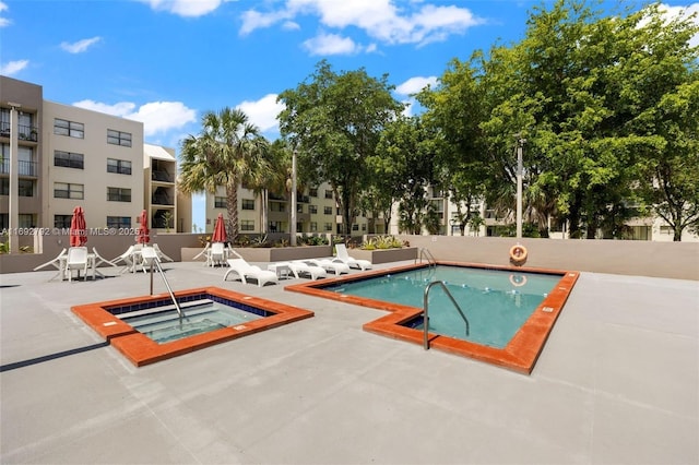 view of swimming pool with a community hot tub and a patio