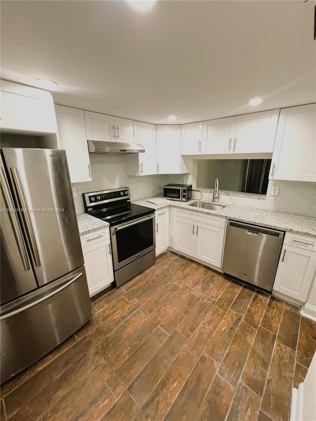 kitchen featuring dark hardwood / wood-style flooring, white cabinets, stainless steel appliances, and sink