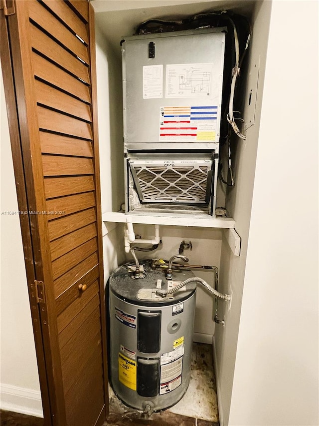 utility room featuring electric water heater and heating unit