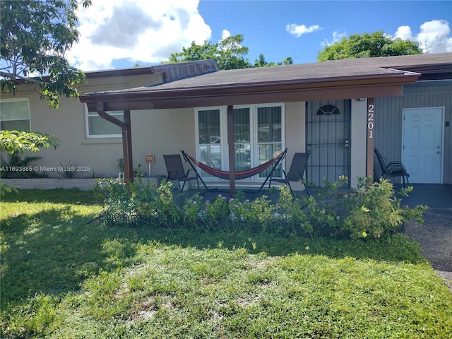 exterior space with a front yard and covered porch