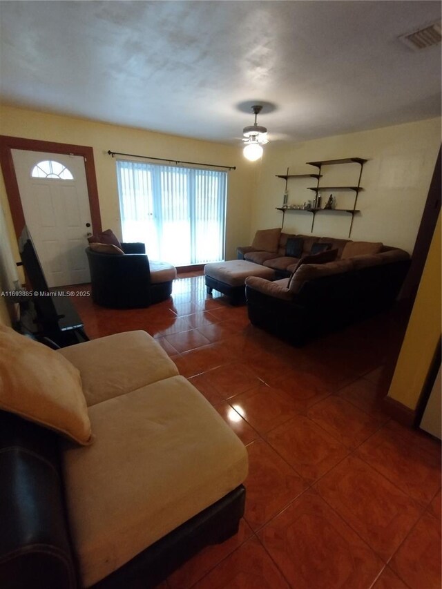 living room with tile patterned floors and ceiling fan