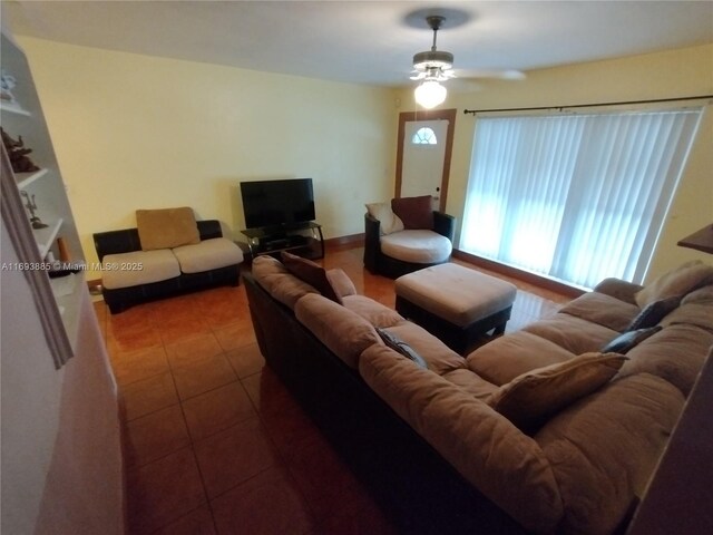 living room featuring tile patterned floors and ceiling fan