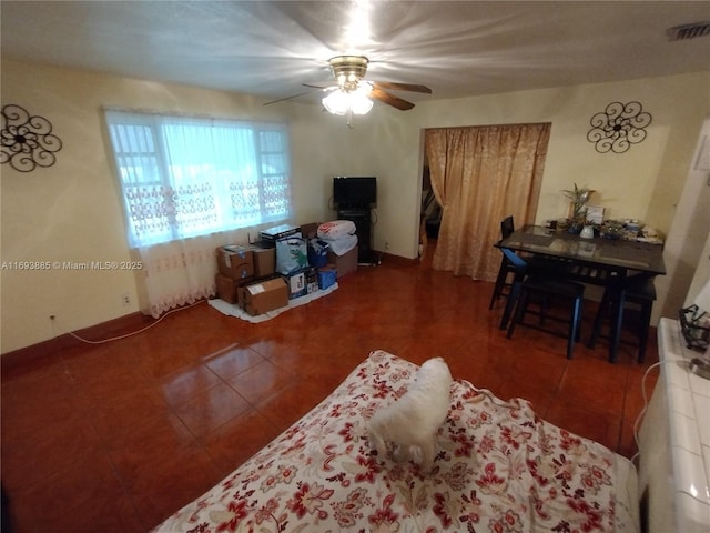 tiled living room featuring ceiling fan