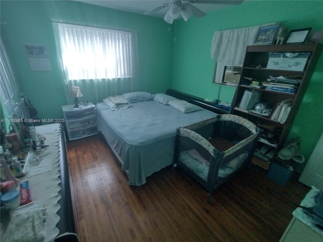 bedroom with ceiling fan, cooling unit, and dark hardwood / wood-style floors