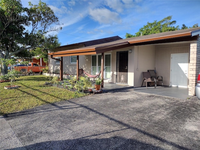 exterior space featuring a patio and a front yard