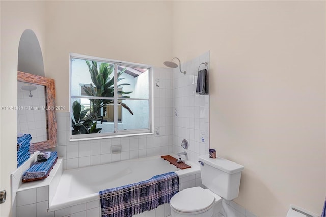 bathroom with radiator heating unit, tiled shower / bath combo, and toilet