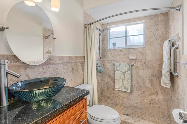 bathroom featuring a shower with curtain, vanity, toilet, and tile walls