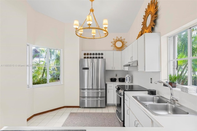 kitchen with hanging light fixtures, sink, light tile patterned floors, appliances with stainless steel finishes, and white cabinetry